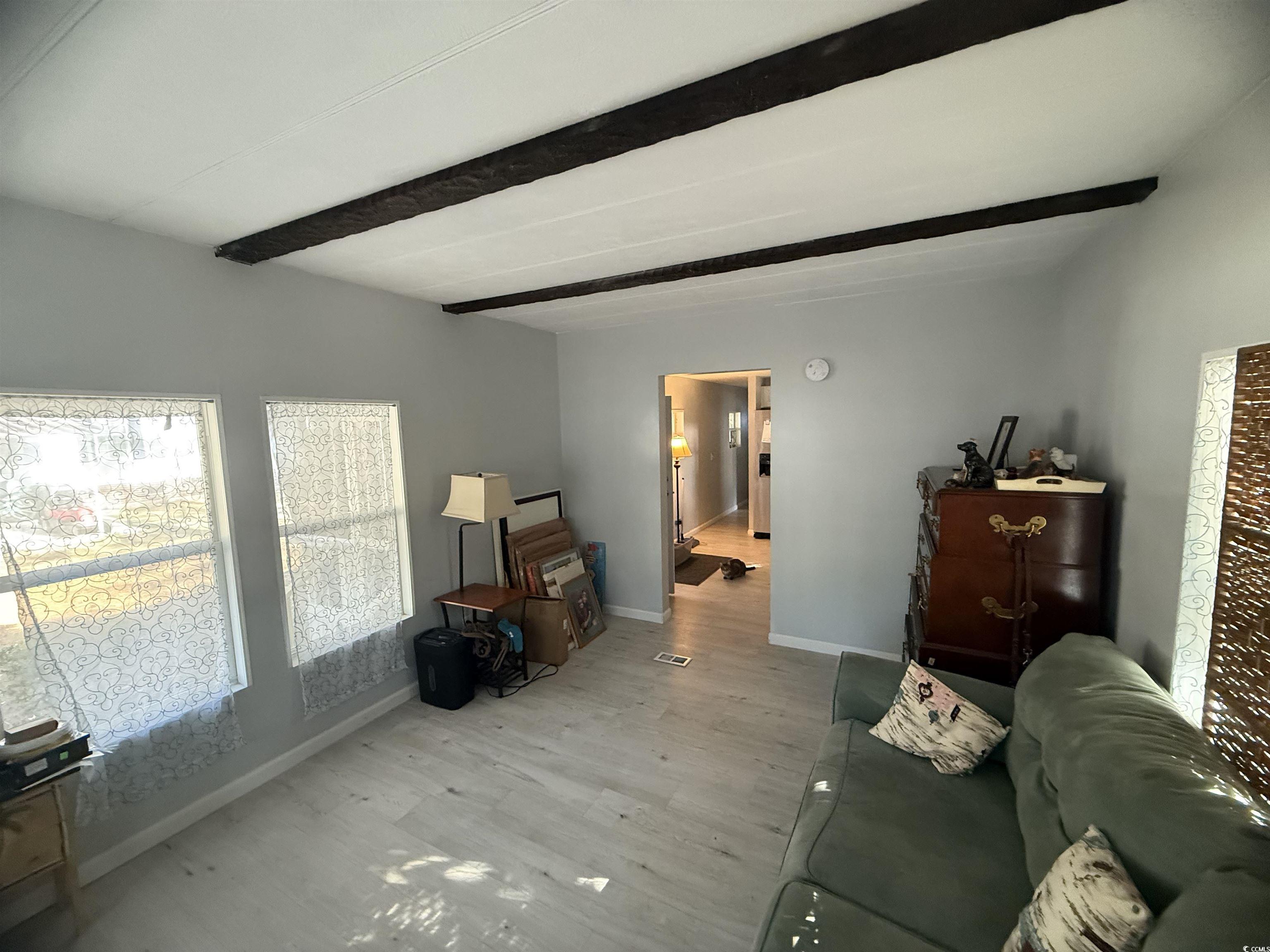 2945 Clemson Trail Murrells Inlet, SC 29576 - Photo 10 of 23 Living room featuring wood finished floors and beamed ceiling