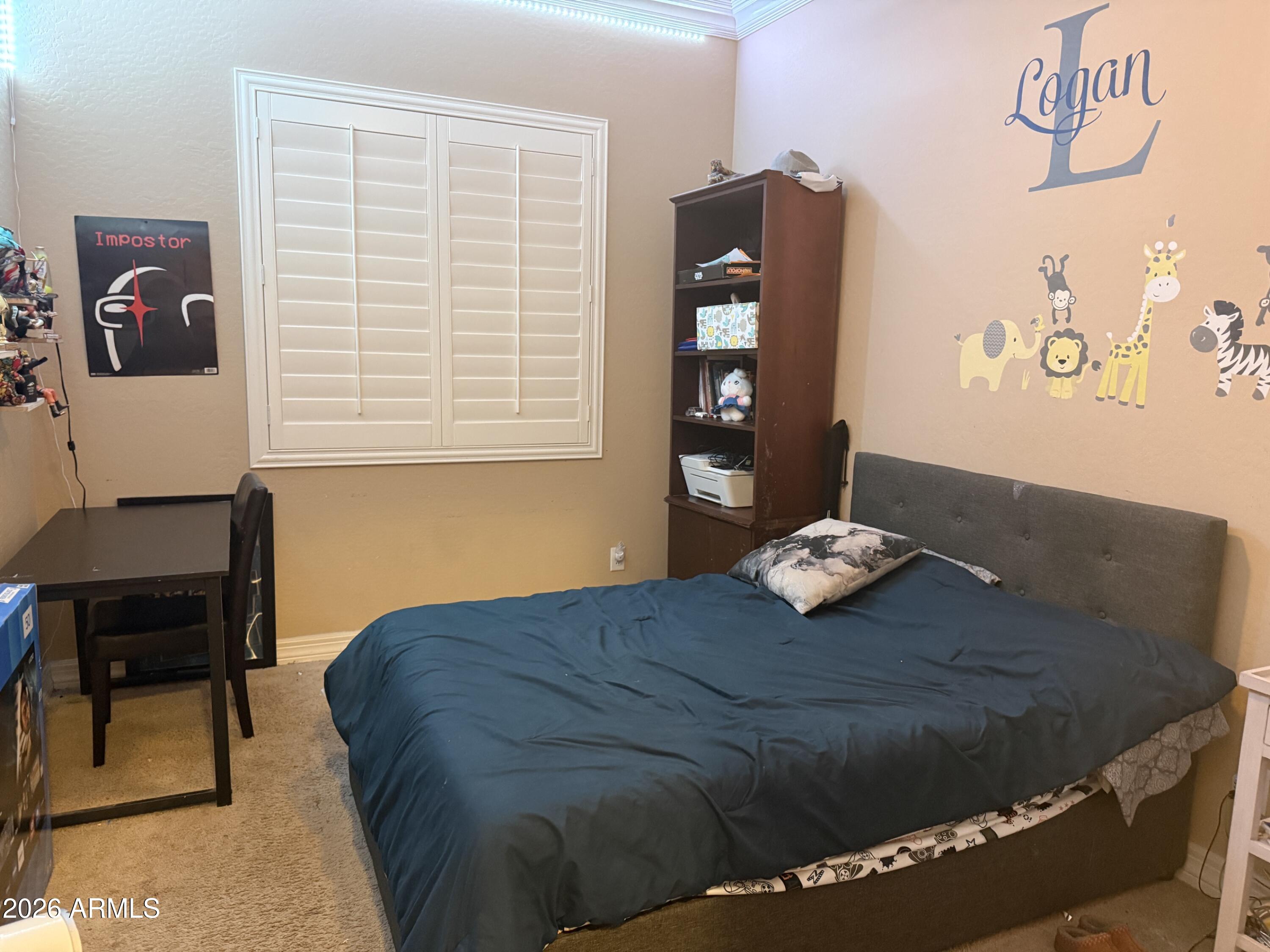 16121 West Berkeley Road Goodyear, AZ 85395 - Photo 12 of 20 a bedroom with a bed and a chair