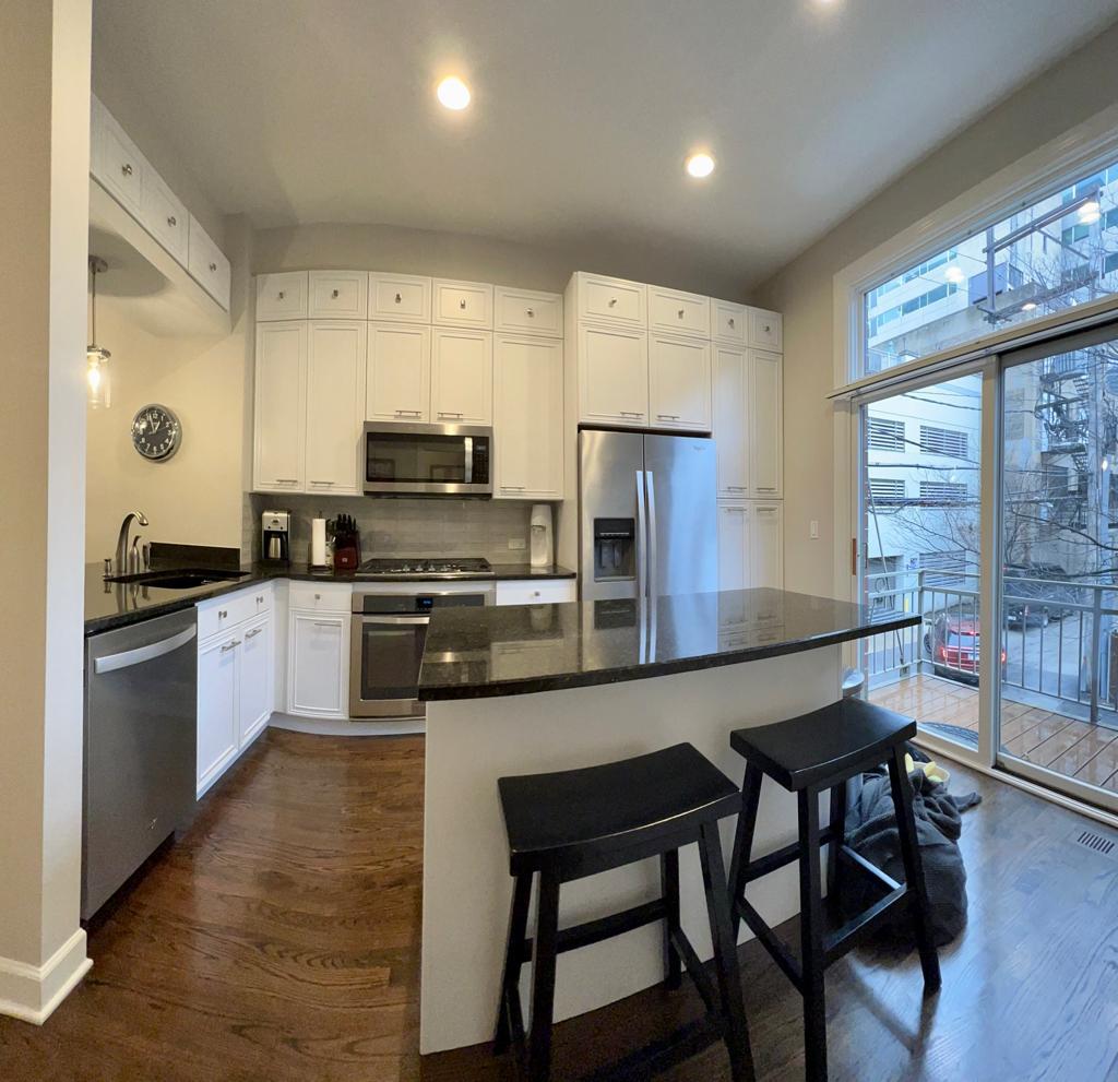 218 East Cullerton Street Chicago, IL 60616 - Photo 13 of 29 a kitchen with granite countertop a stove a sink a refrigerator and a dining table