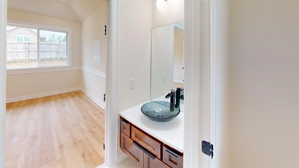 2509 Windmill Lane Longview, TX 75601 - Photo 19 of 35 Bathroom featuring wood finished floors and vanity