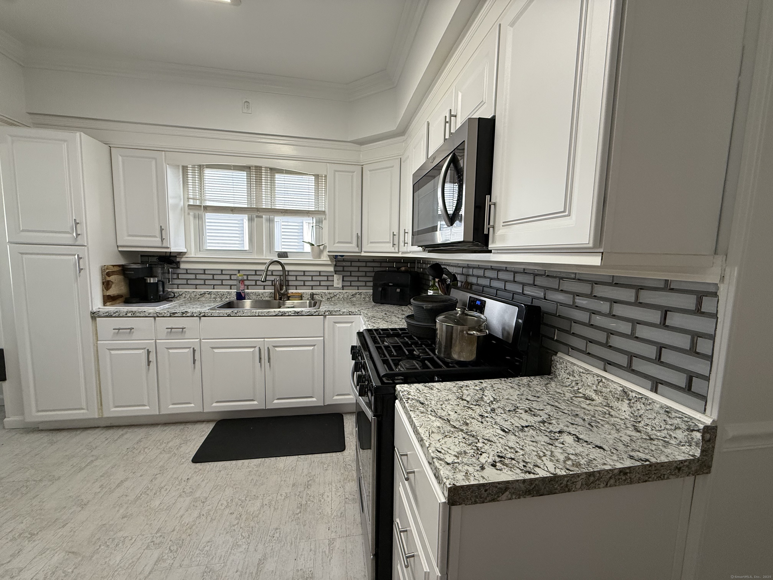 1049 Campbell Avenue West Haven, CT 06516 - Photo 14 of 20 a kitchen with a sink stove and cabinets