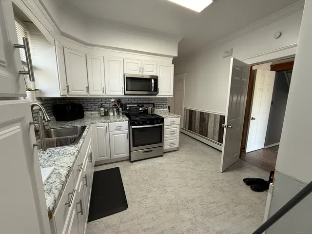 a kitchen with stainless steel appliances a stove a sink and a microwave