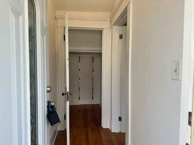 a view of a hallway with wooden floor