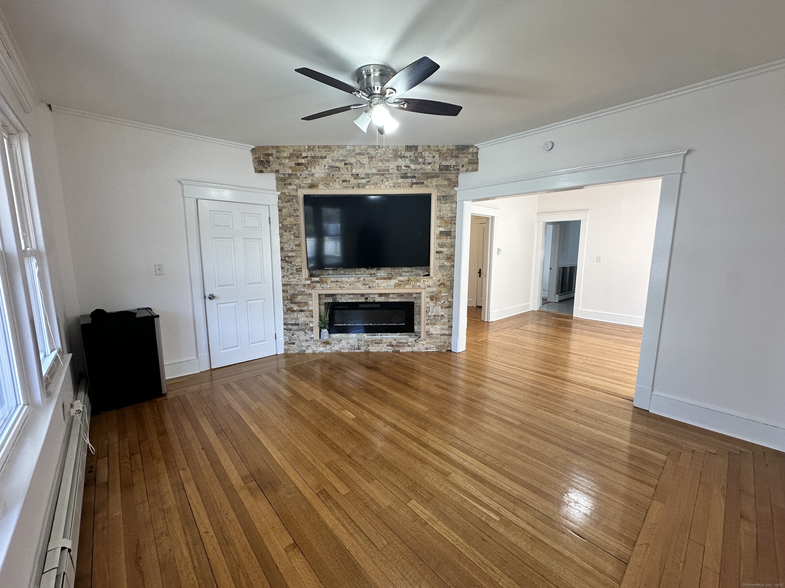 1049 Campbell Avenue West Haven, CT 06516 - Photo 6 of 20 a view of a livingroom with a fireplace a chandelier and wooden floor