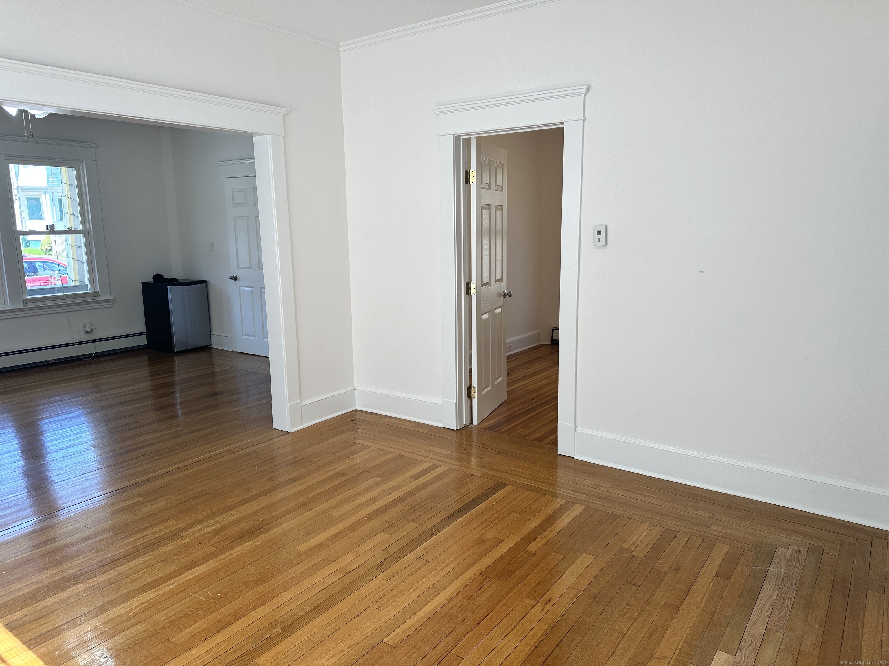 1049 Campbell Avenue West Haven, CT 06516 - Photo 8 of 20 an empty room with wooden floor and windows
