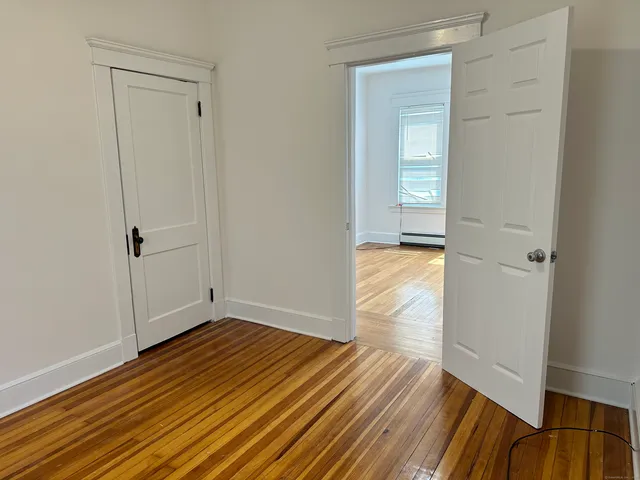 a view of a room with wooden floor and closet