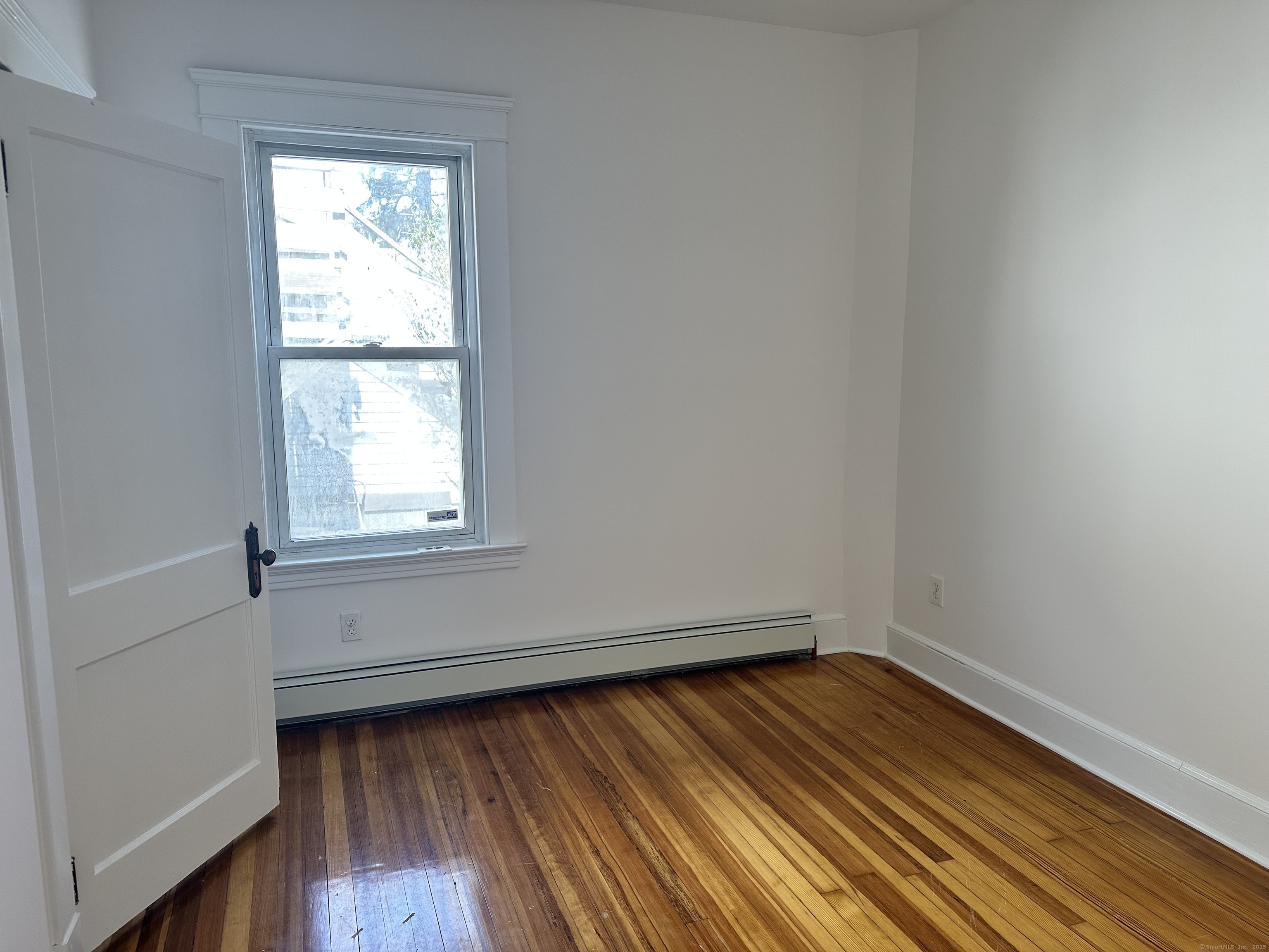 1049 Campbell Avenue West Haven, CT 06516 - Photo 10 of 20 an empty room with wooden floor and windows