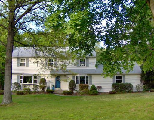 105 Whisconier Road Brookfield, CT 06804 - Photo 1 of 1 a front view of a house with a garden and trees