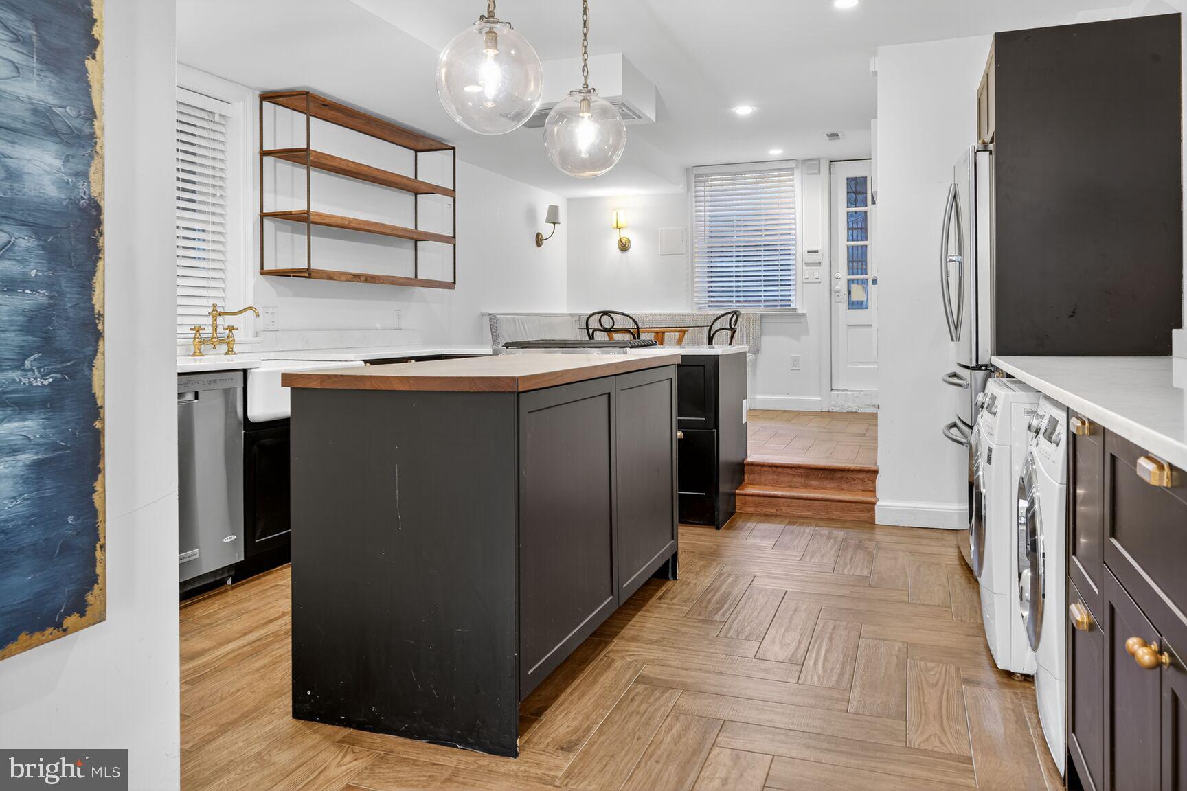 1511 34th Street Northwest Washington, DC 20007 - Photo 12 of 30 a large kitchen with stainless steel appliances a large counter top a stove a sink and a refrigerator