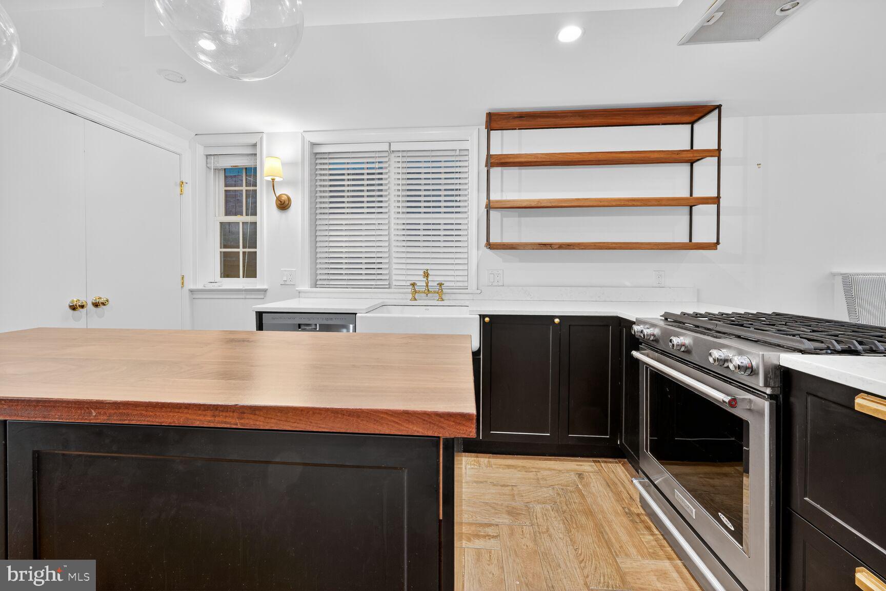 1511 34th Street Northwest Washington, DC 20007 - Photo 13 of 30 a kitchen with stainless steel appliances granite countertop a stove a sink and a microwave