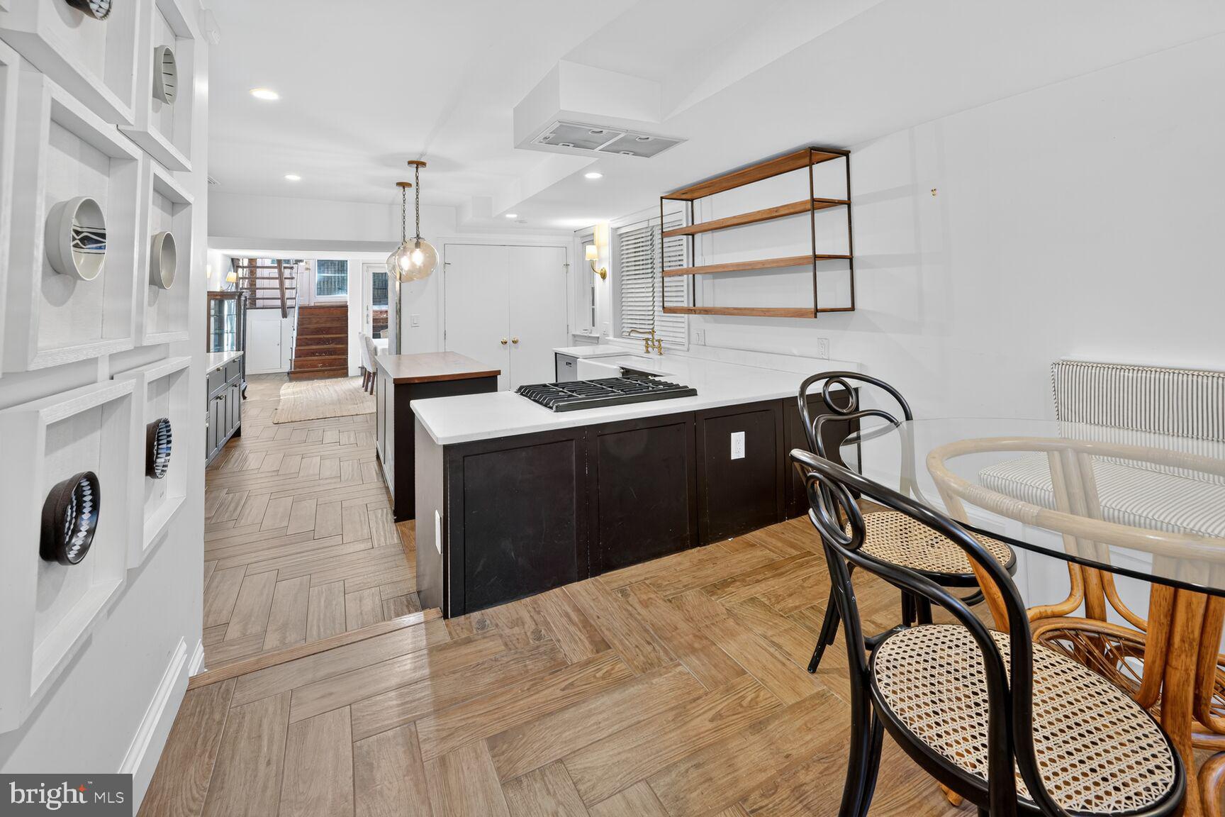 1511 34th Street Northwest Washington, DC 20007 - Photo 15 of 30 a kitchen with a table chairs sink and cabinets