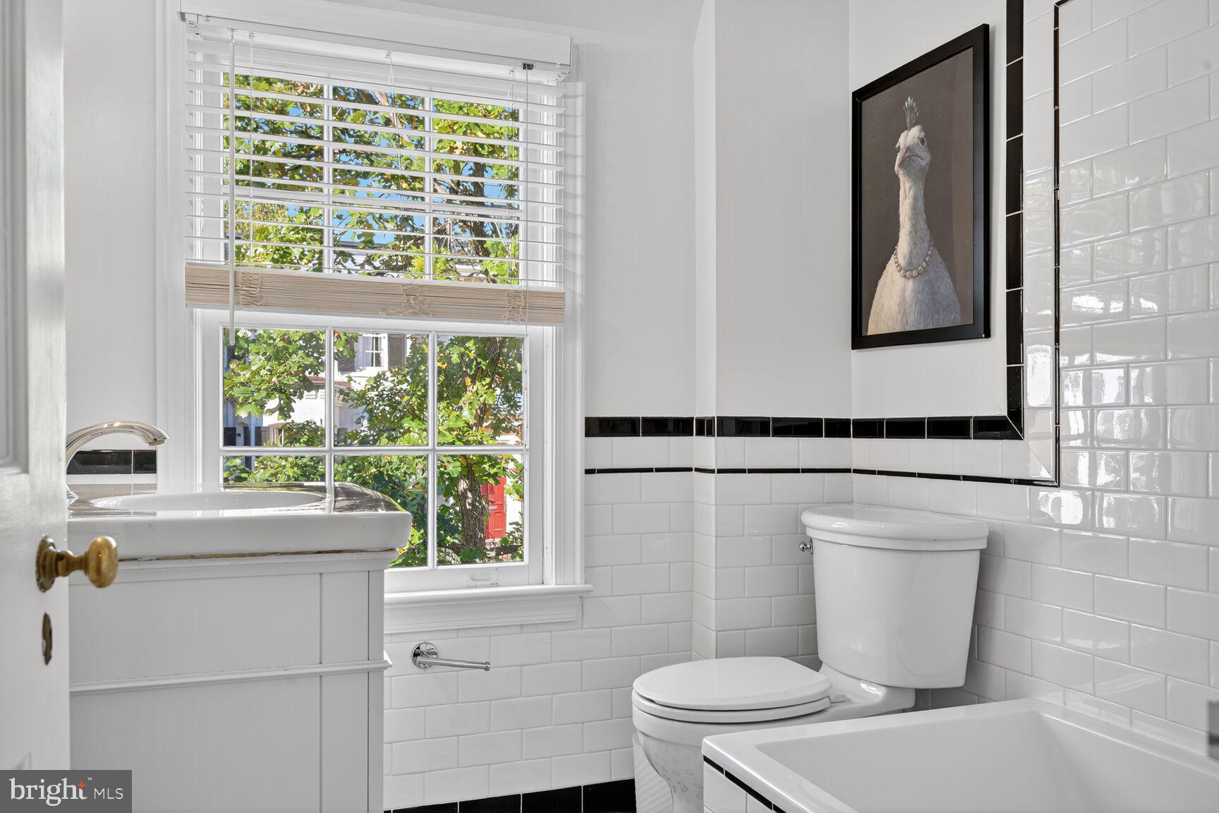 1511 34th Street Northwest Washington, DC 20007 - Photo 21 of 30 a bathroom with a toilet a sink and a window