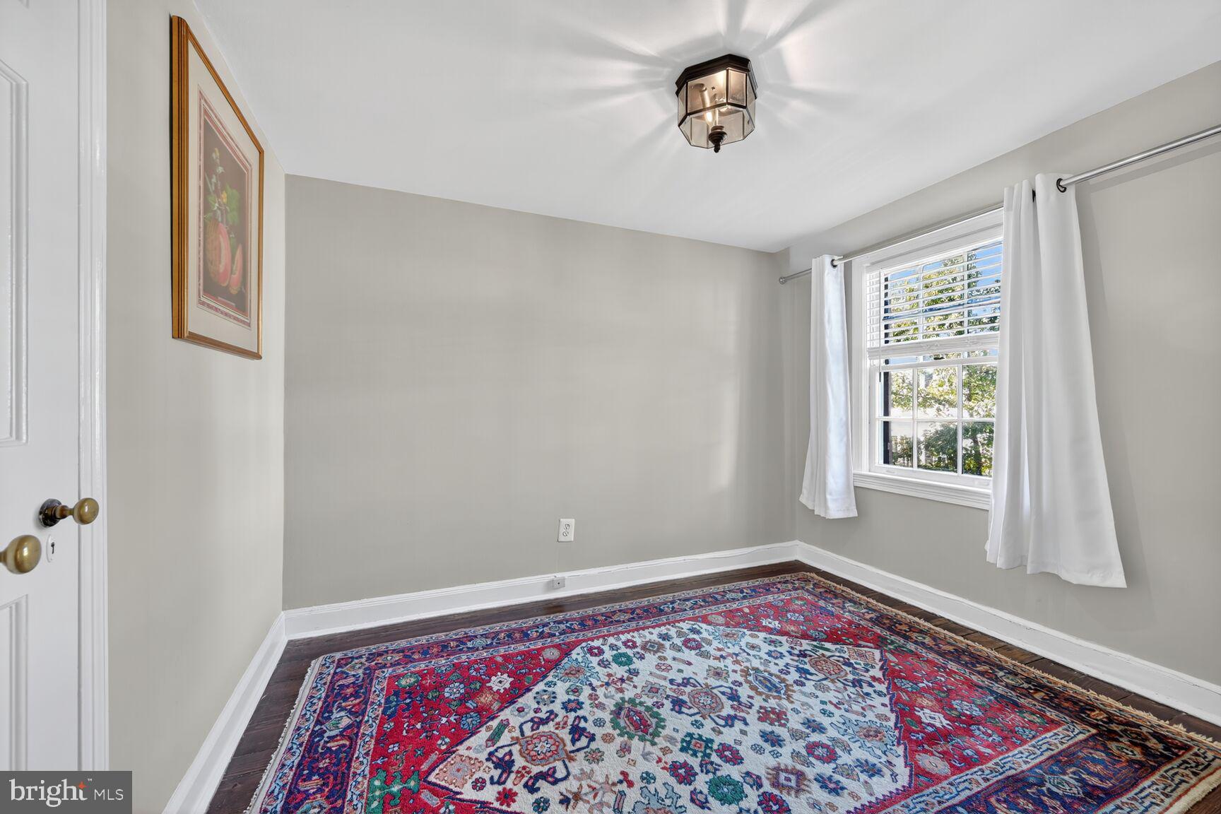 1511 34th Street Northwest Washington, DC 20007 - Photo 22 of 30 a view of a hallway with a window and a chandelier