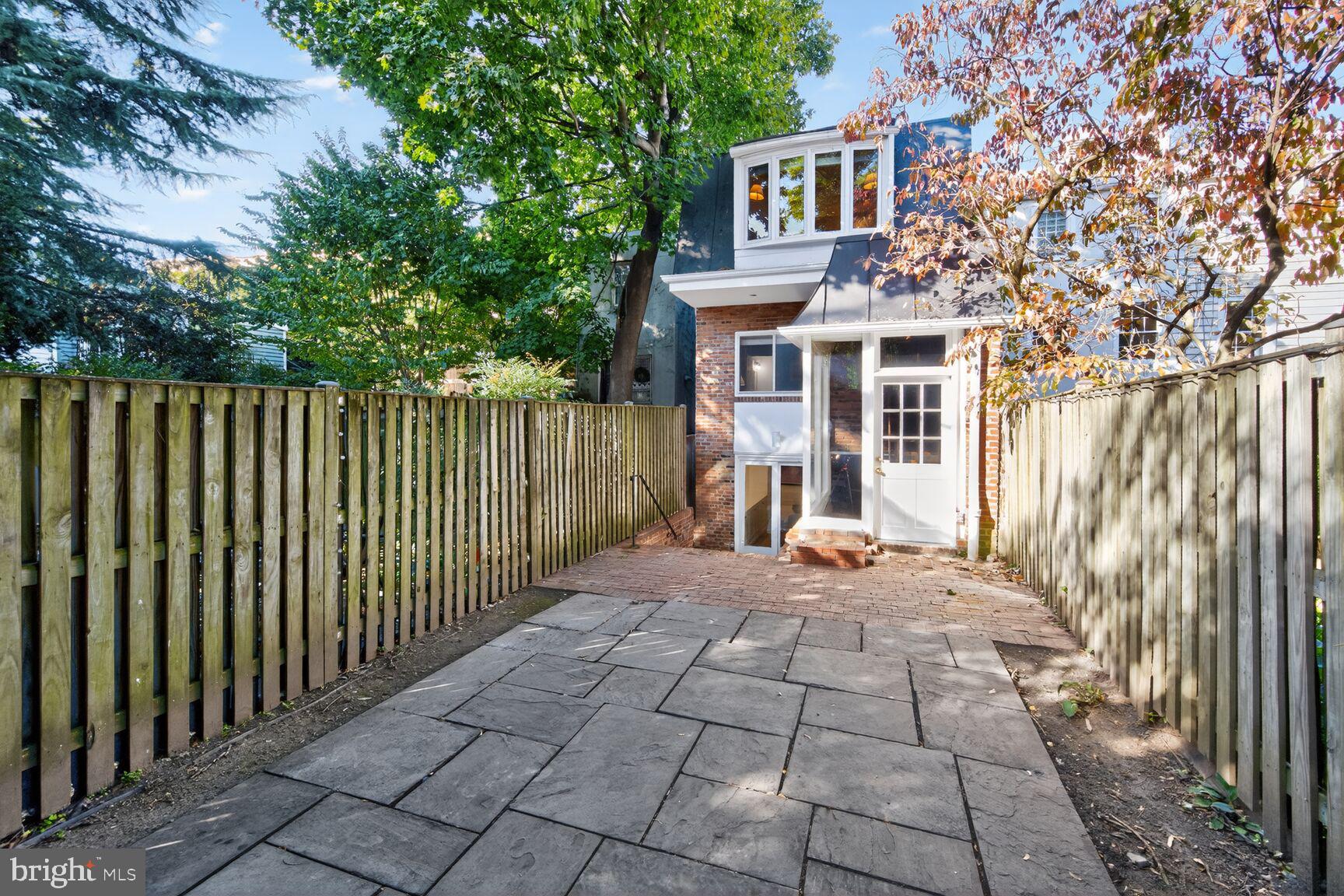 1511 34th Street Northwest Washington, DC 20007 - Photo 28 of 30 a view of a house with a small yard and large trees