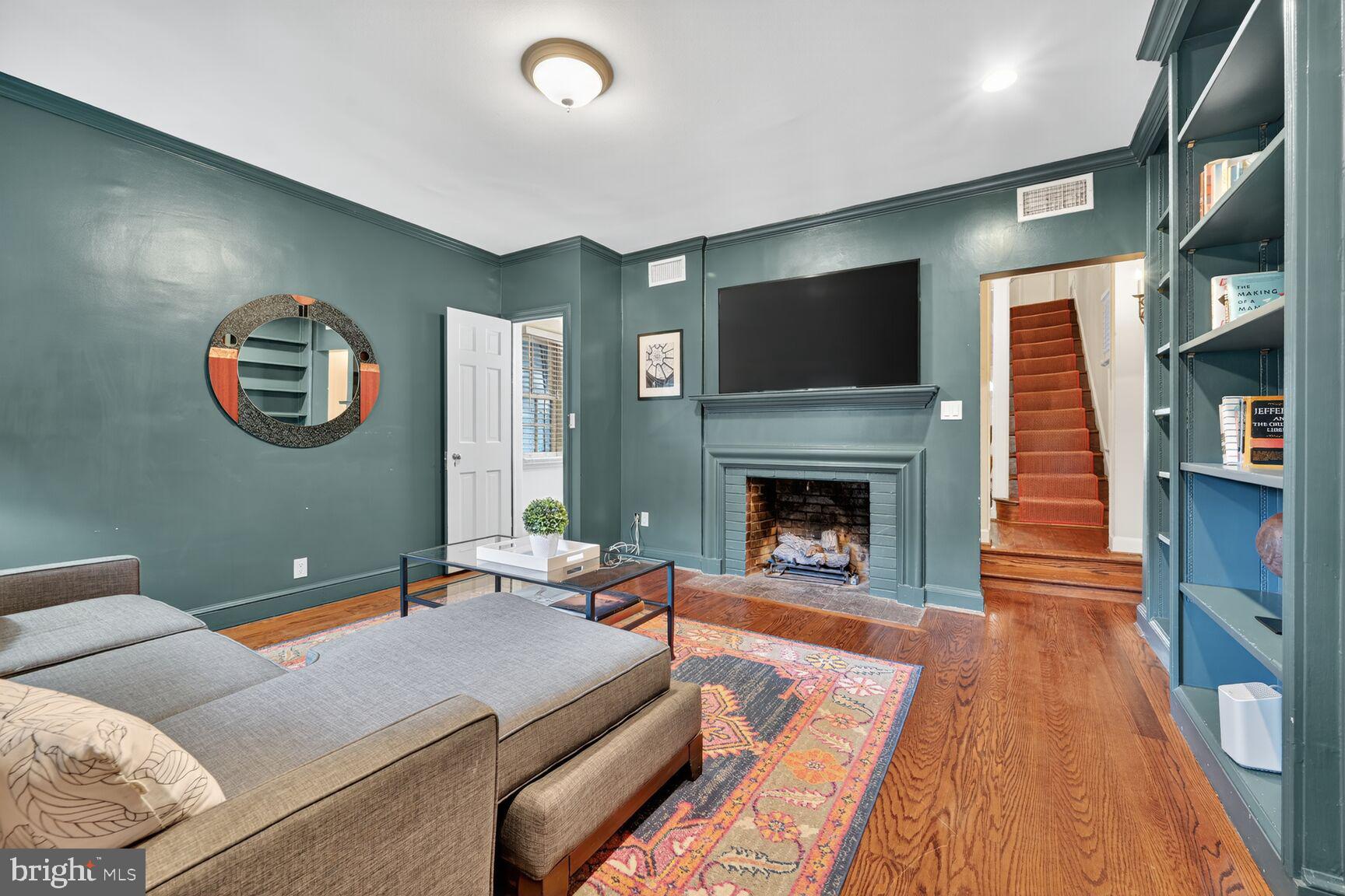 1511 34th Street Northwest Washington, DC 20007 - Photo 5 of 30 a living room with furniture and a fireplace
