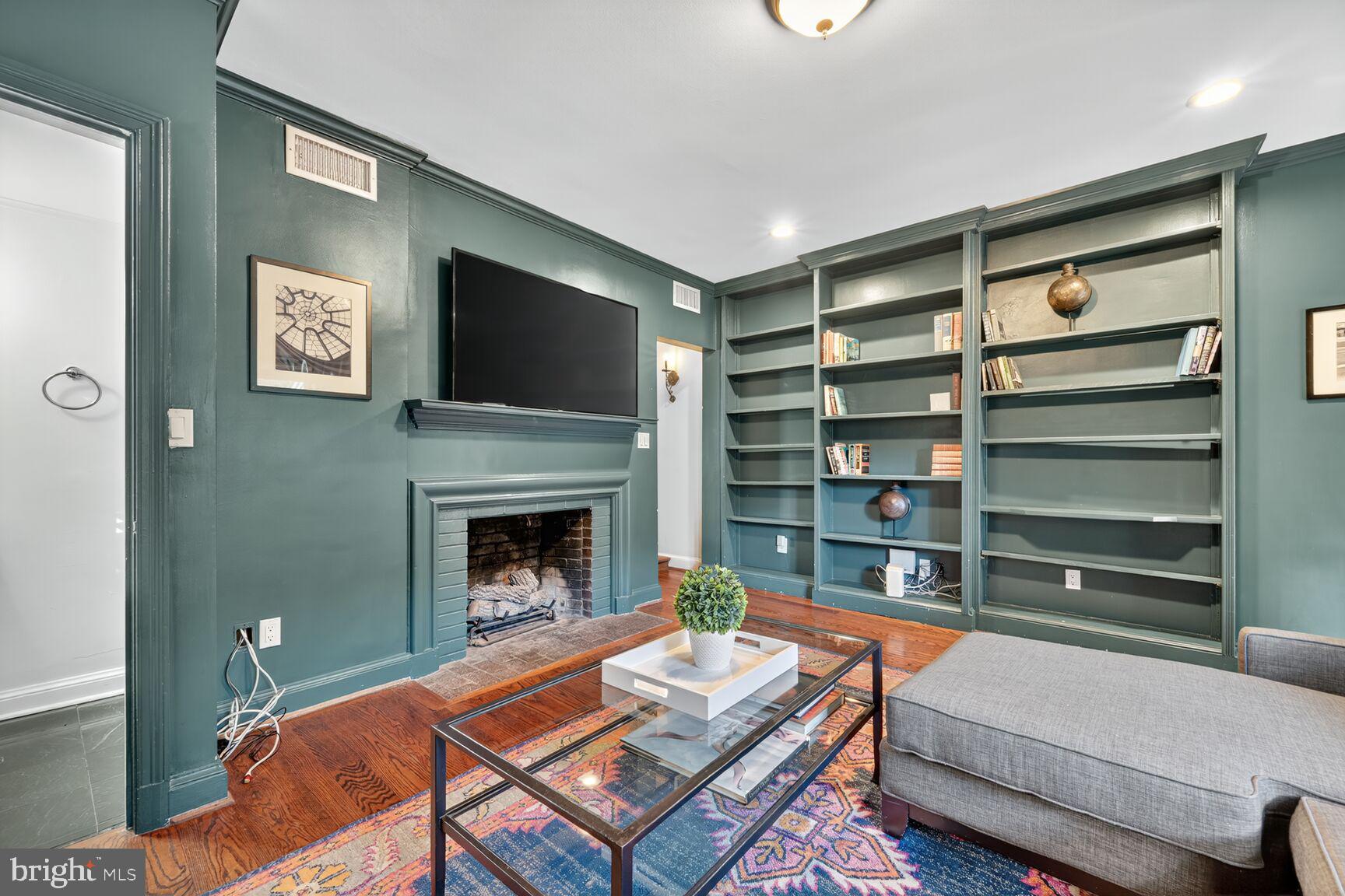1511 34th Street Northwest Washington, DC 20007 - Photo 6 of 30 a living room with furniture and a fireplace