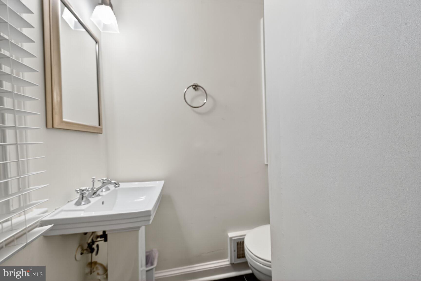 1511 34th Street Northwest Washington, DC 20007 - Photo 7 of 30 a bathroom with a sink a toilet and mirror