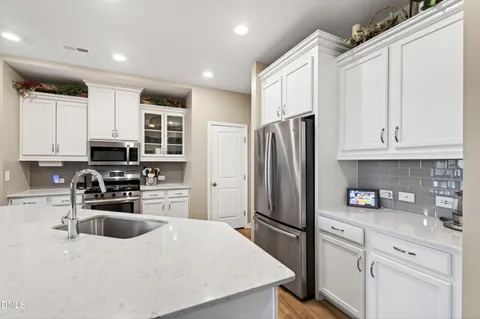 a kitchen with stainless steel appliances a refrigerator sink and cabinets