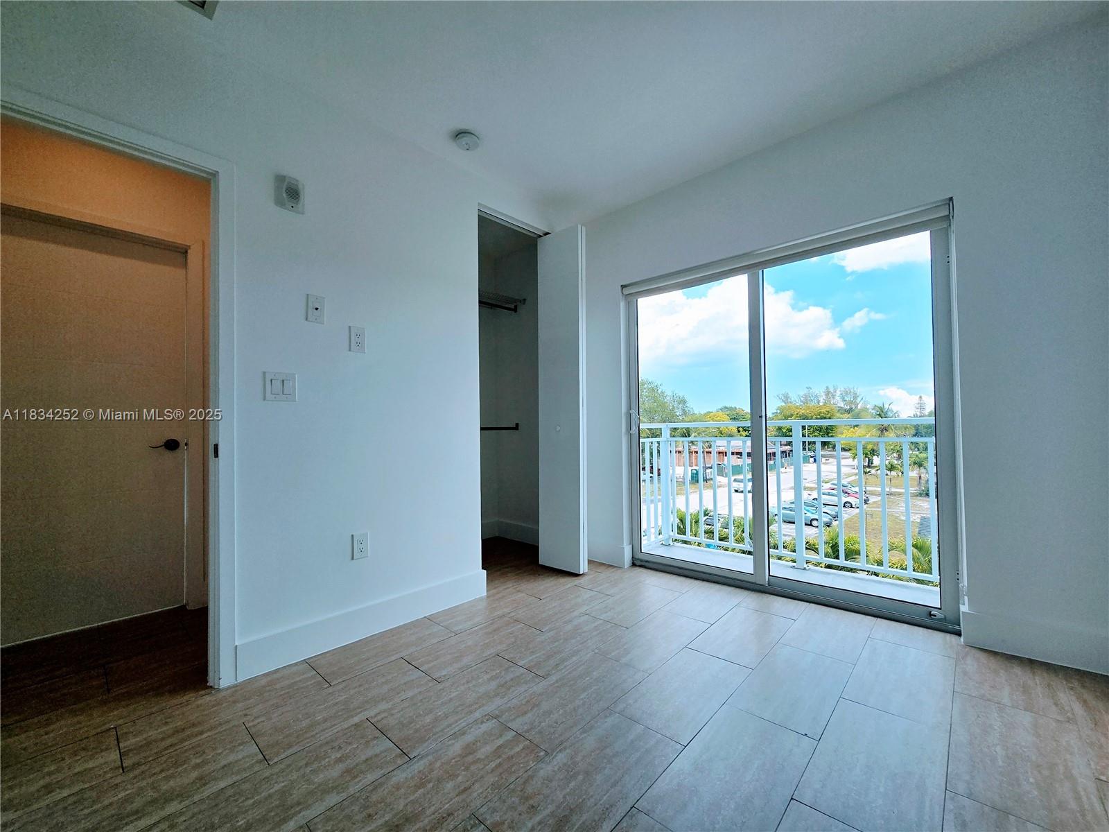 6336 Southwest 27th Street, Unit 8 Miramar, FL 33023 - Photo 13 of 16 an empty room with wooden floor and windows