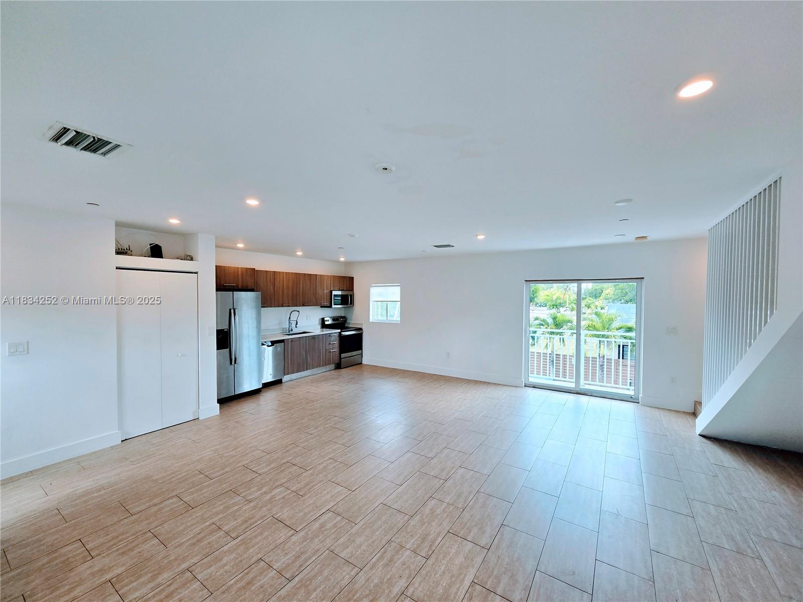6336 Southwest 27th Street, Unit 8 Miramar, FL 33023 - Photo 3 of 16 an empty room with wooden floor and windows
