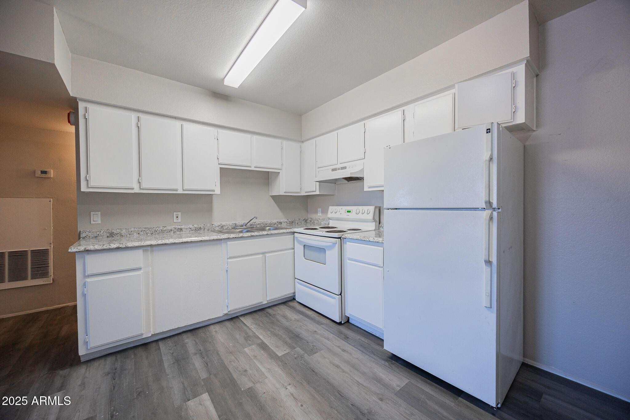 1703 West Mountain View Road, Unit 14 Phoenix, AZ 85021 - Photo 5 of 14 a kitchen with a refrigerator sink stove and cabinets