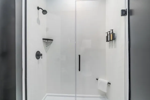 a bathroom with a double vanity sink toilet and shower