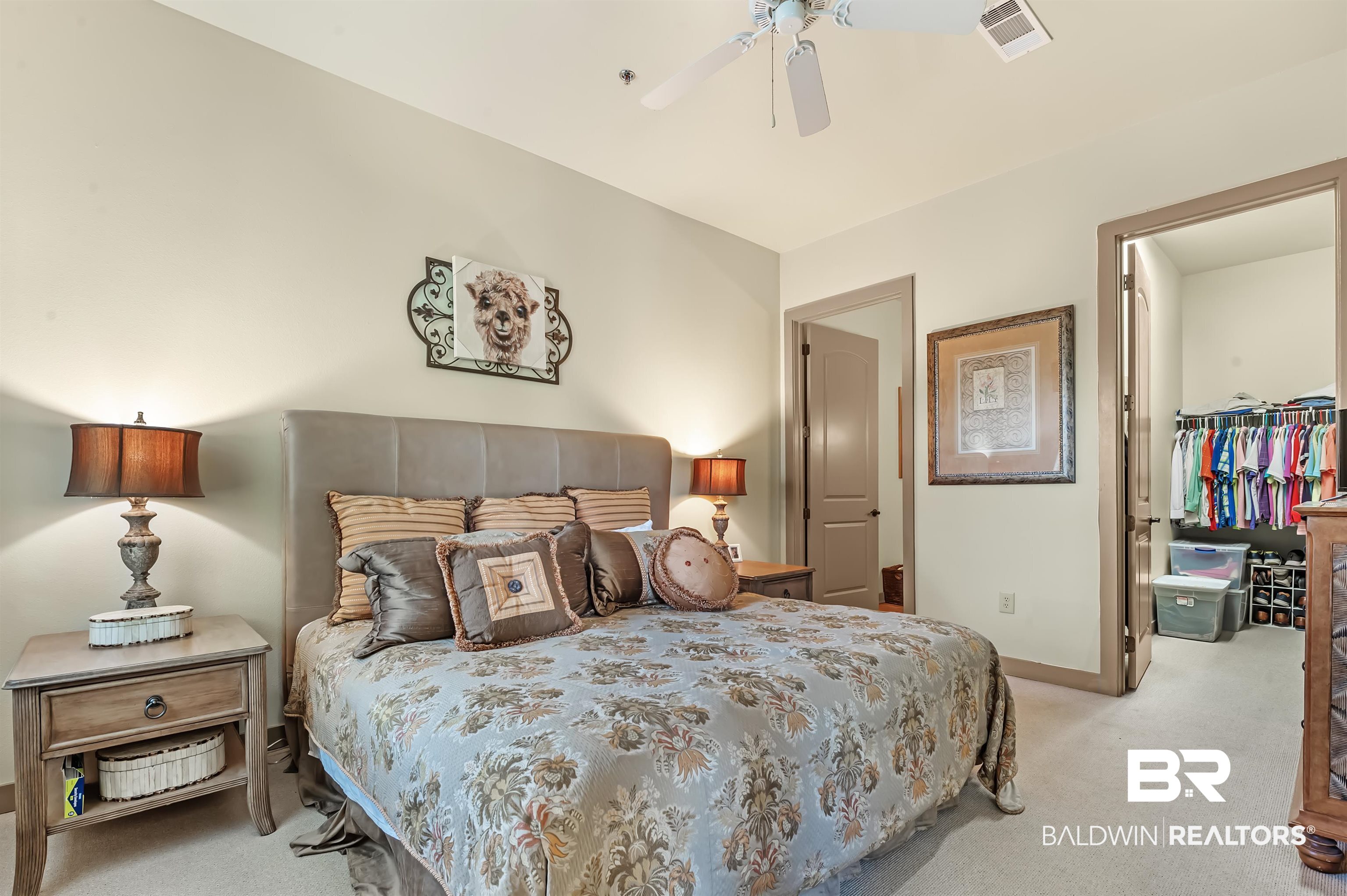 1430 Regency Road, Unit A301 Gulf Shores, AL 36542 - Photo 22 of 47 Carpeted bedroom with a closet, ceiling fan, and a walk in closet