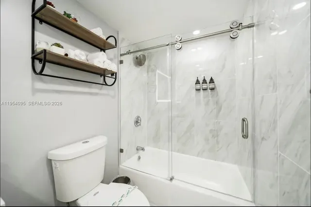 a bathroom with a shower a toilet and a shower