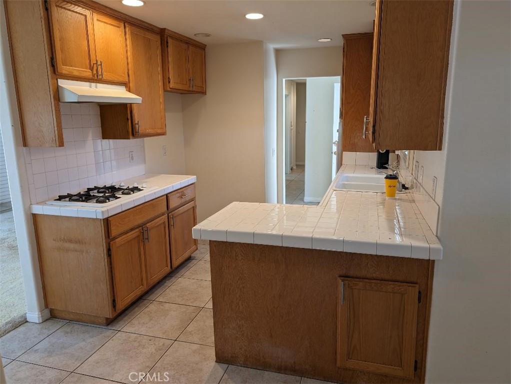 5331 Sunnyside Drive Riverside, CA 92504 - Photo 10 of 25 a kitchen with stainless steel appliances a sink stove and cabinets