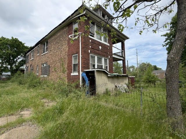 304 Polk Street Gary, IN 46402 - Photo 2 of 26 a backyard of a house with lots of green space