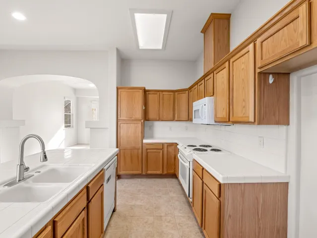 a kitchen with a sink stove and cabinets