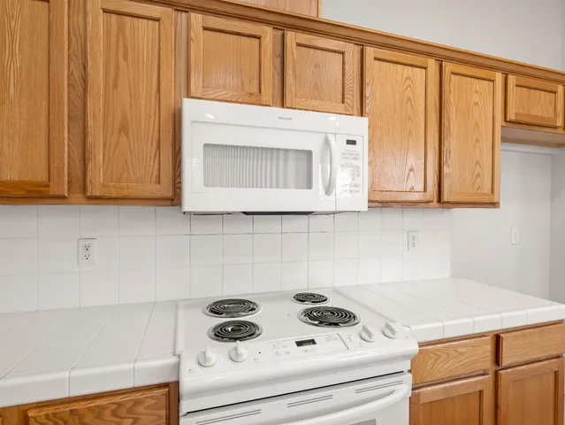a kitchen with stainless steel appliances a cabinets and a stove top oven