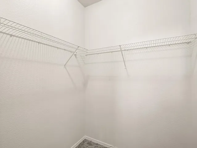 a view of a balcony with wooden floor and fence