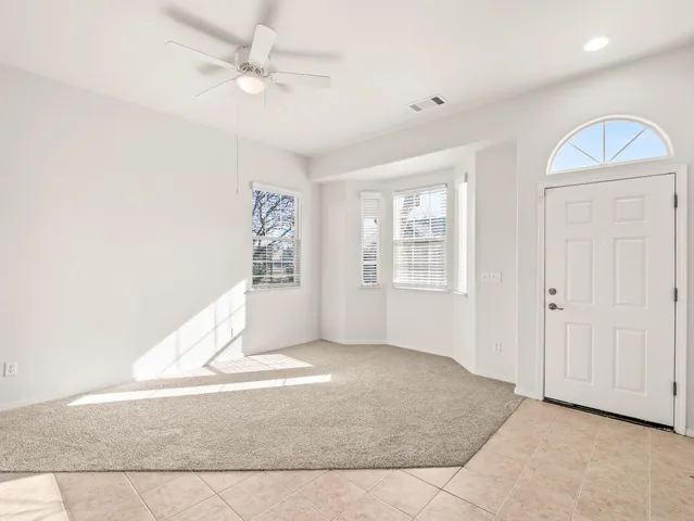 an empty room with windows and cabinet