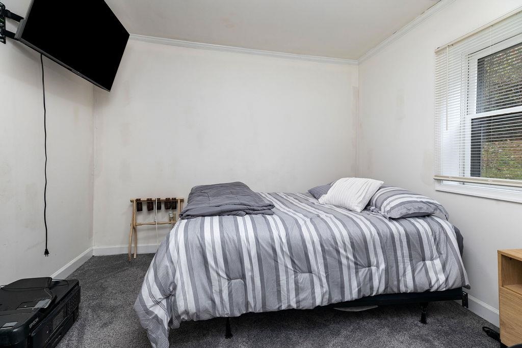 1623 East Main Street Waynesboro, VA 22980 - Photo 11 of 20 a bed sitting in a bedroom next to a window