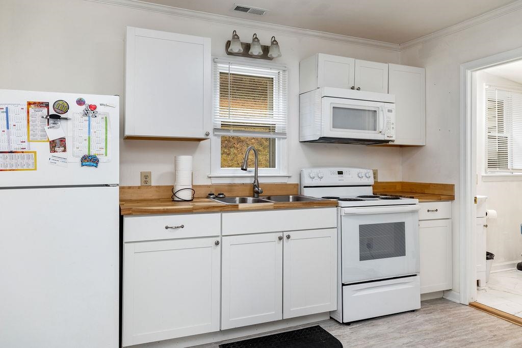1623 East Main Street Waynesboro, VA 22980 - Photo 7 of 20 a kitchen with white cabinets and white appliances