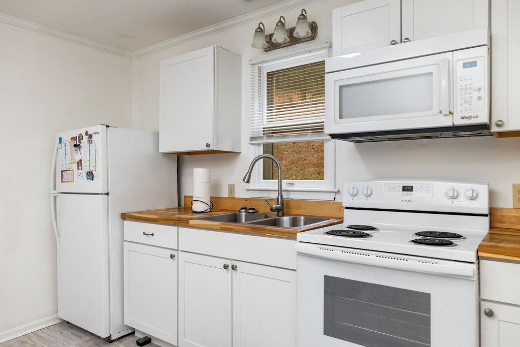 1623 East Main Street Waynesboro, VA 22980 - Photo 8 of 20 a kitchen with stainless steel appliances a stove a microwave and a refrigerator