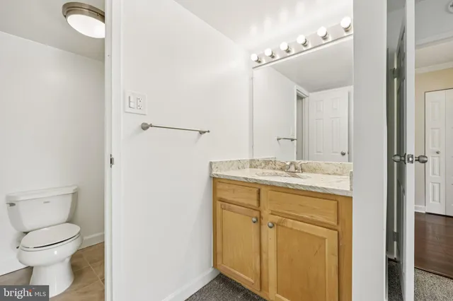 a white toilet sitting next to a shower