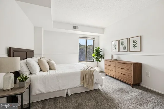 a living room with furniture and a dresser