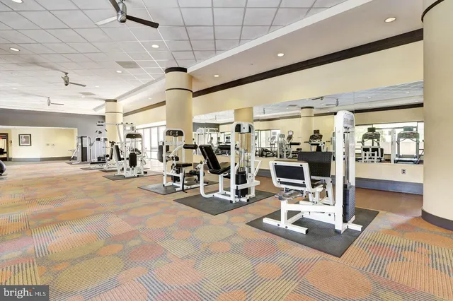 a living room with furniture large window and a flat screen tv