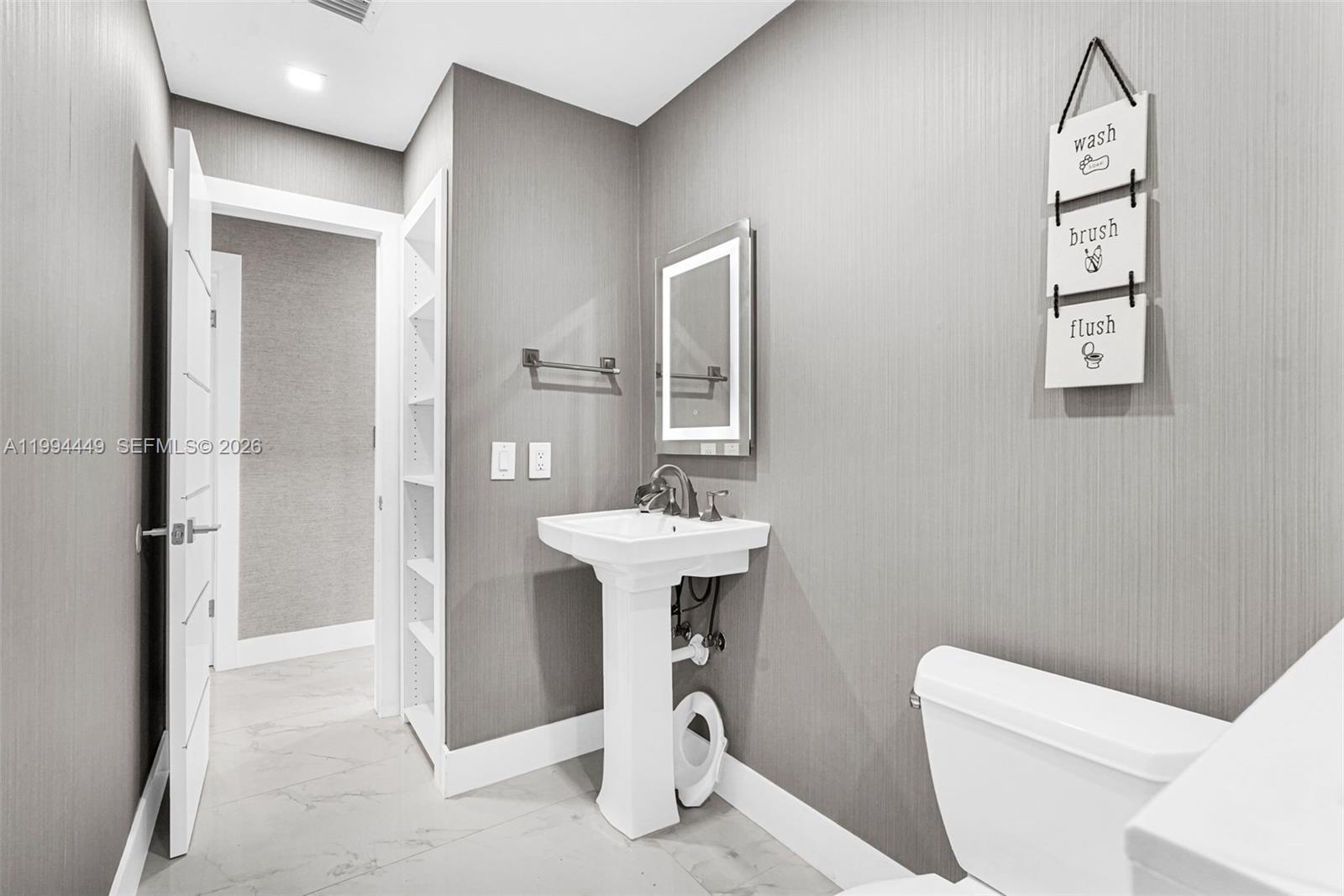 4225 Southwest 133rd Court Miami, FL 33175 - Photo 25 of 53 a bathroom with a toilet a sink and a mirror