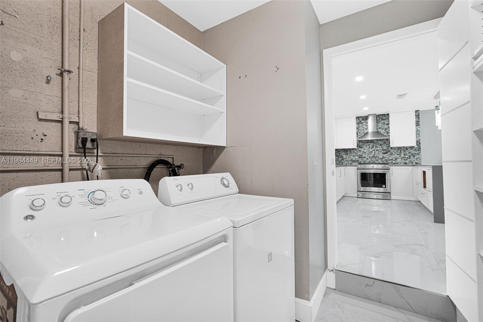4225 Southwest 133rd Court Miami, FL 33175 - Photo 37 of 53 a view of washer and dryer with kitchen in the background
