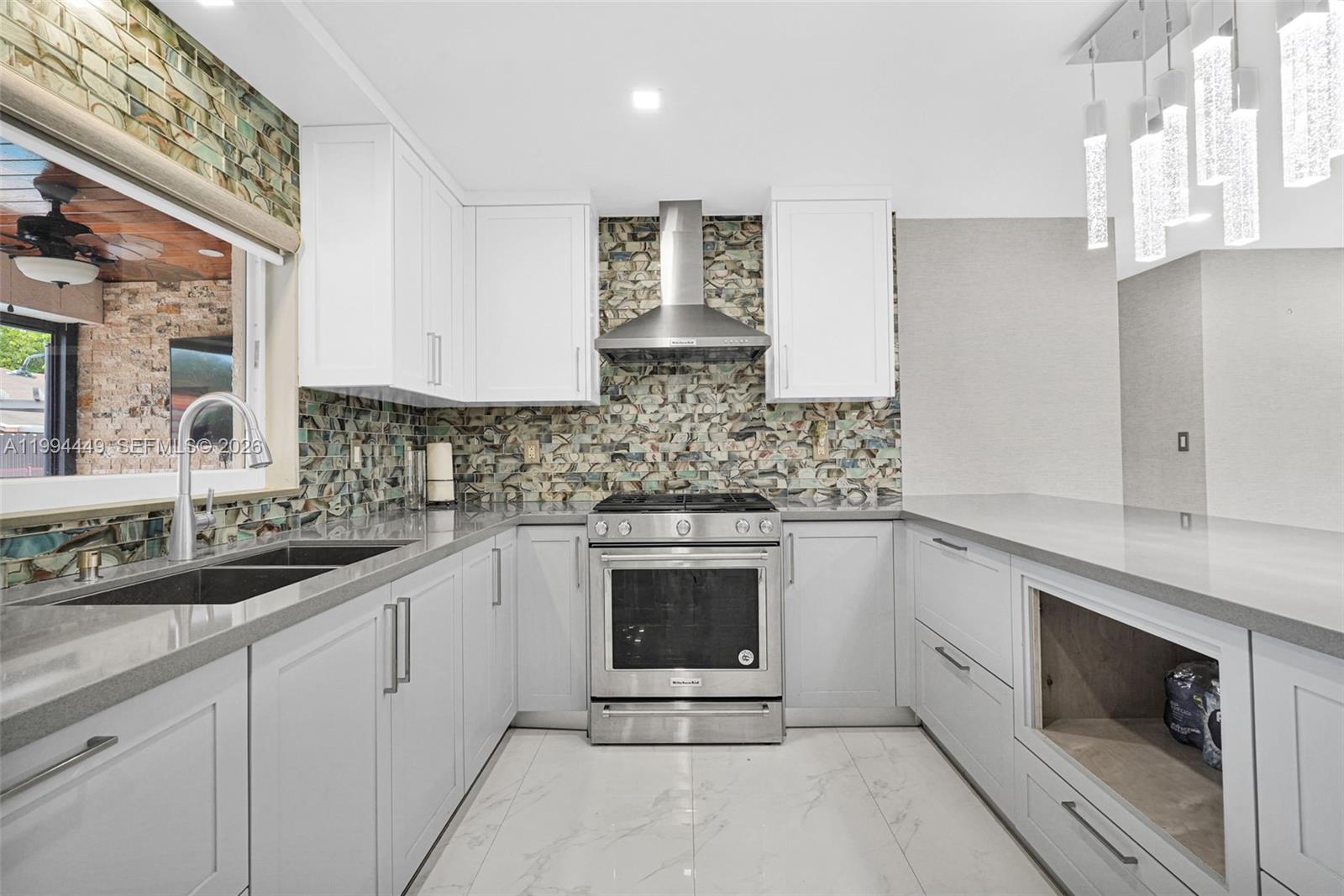 4225 Southwest 133rd Court Miami, FL 33175 - Photo 5 of 53 a kitchen with granite countertop white cabinets stainless steel appliances and sink