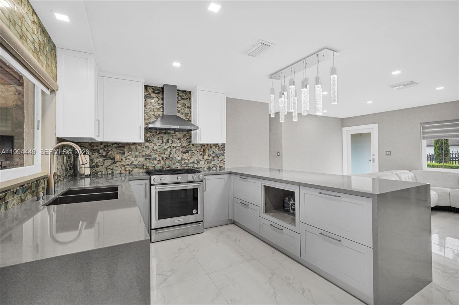 4225 Southwest 133rd Court Miami, FL 33175 - Photo 8 of 53 a kitchen with stainless steel appliances granite countertop a sink and stove top oven
