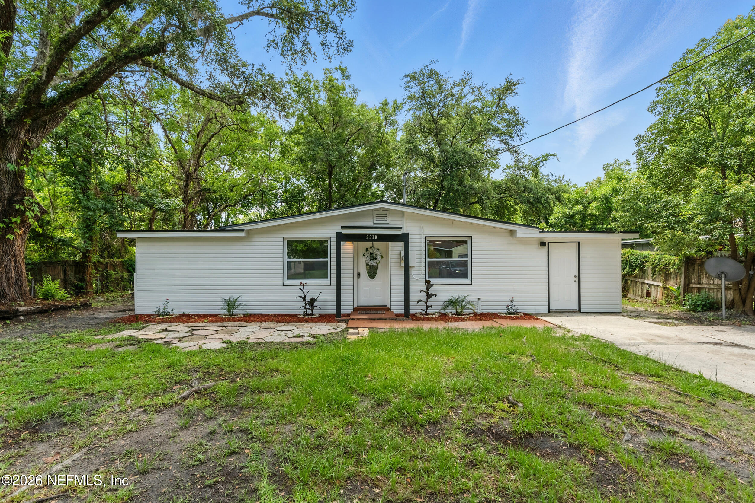 3530 Shadow Street Jacksonville, FL 32254 - Photo 10 of 32 a front view of a house with a yard and garage