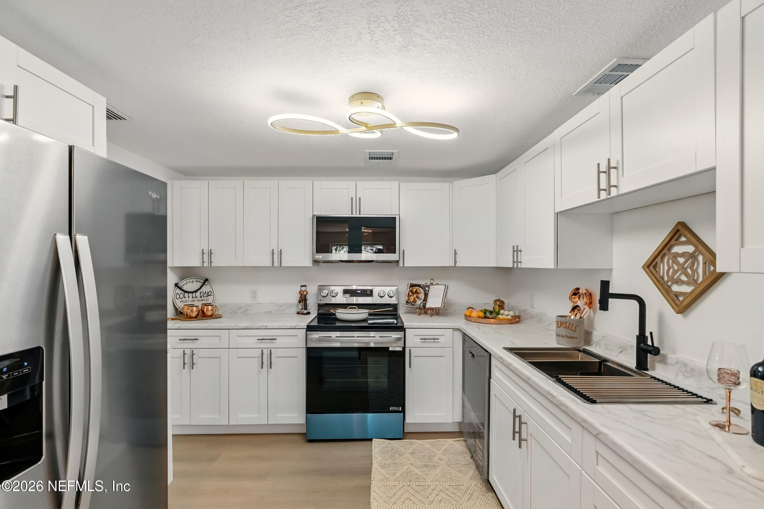 3530 Shadow Street Jacksonville, FL 32254 - Photo 2 of 32 a kitchen with stainless steel appliances granite countertop a sink a stove a refrigerator and cabinets