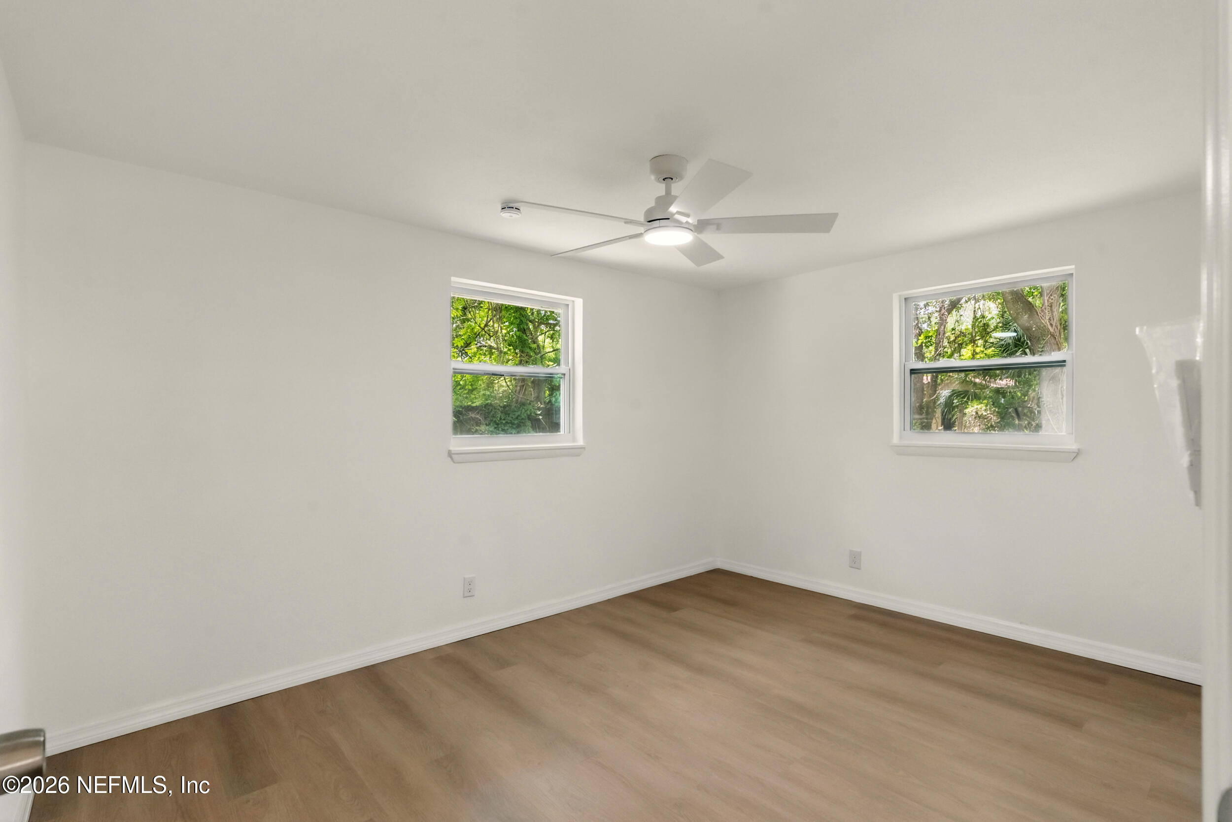 3530 Shadow Street Jacksonville, FL 32254 - Photo 23 of 32 an empty room with wooden floor and ceiling fan