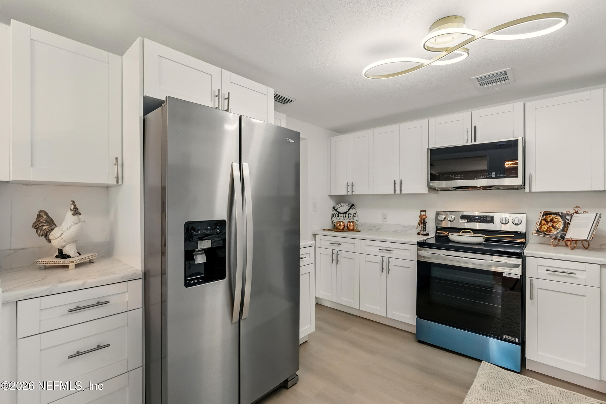 3530 Shadow Street Jacksonville, FL 32254 - Photo 3 of 32 a kitchen with a refrigerator stove and sink