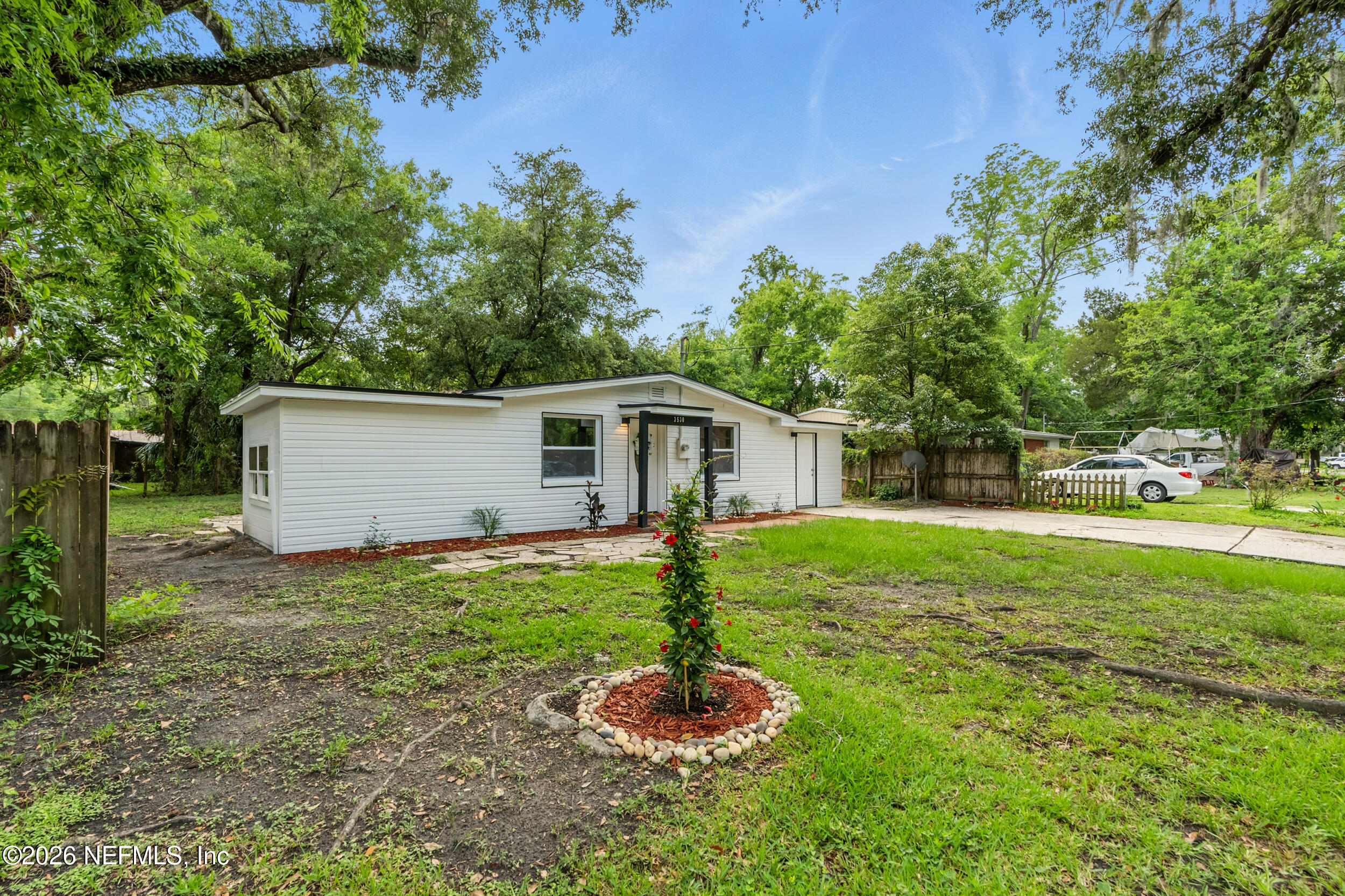 3530 Shadow Street Jacksonville, FL 32254 - Photo 30 of 32 a backyard of a house with plants and tree