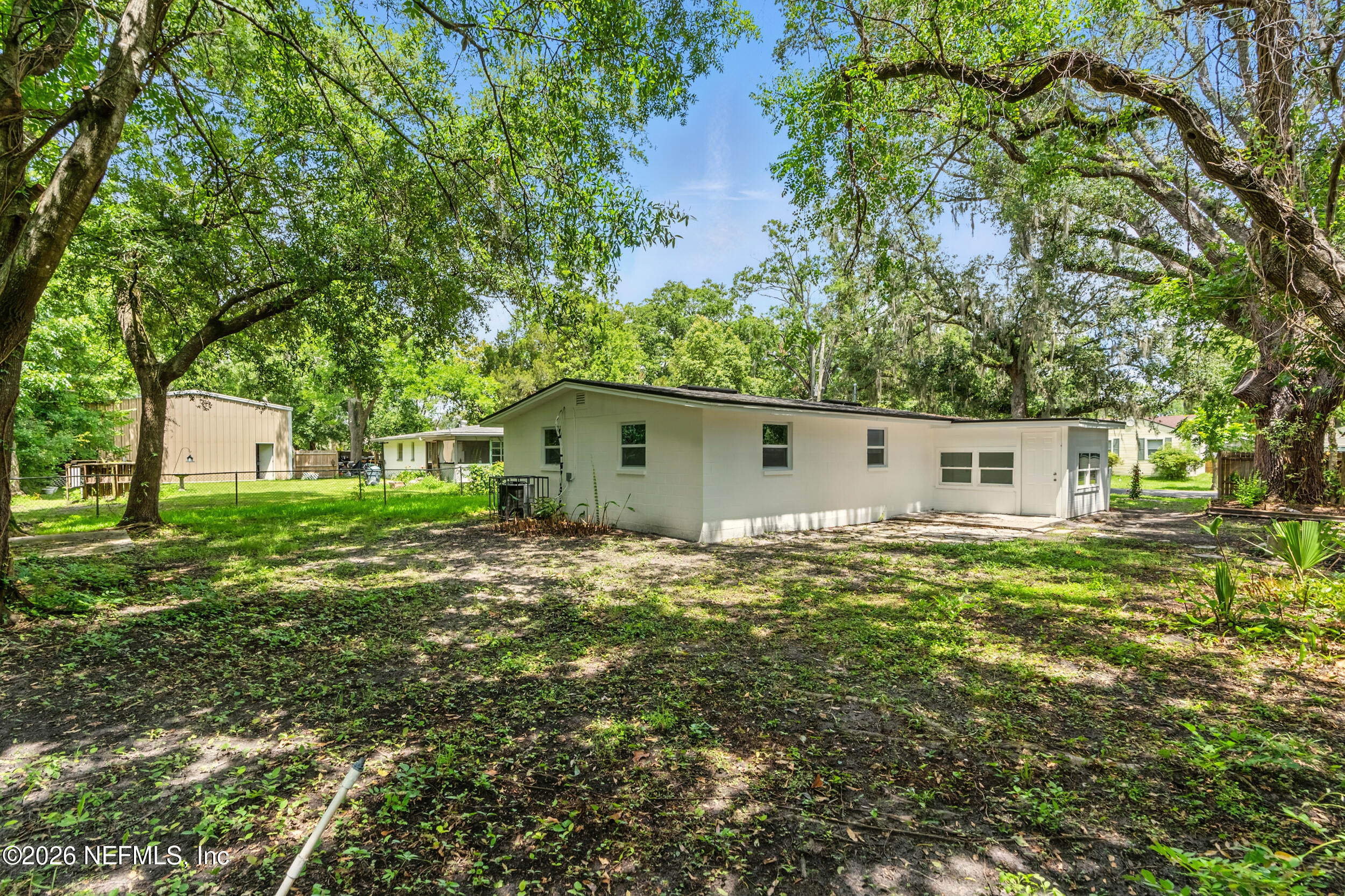 3530 Shadow Street Jacksonville, FL 32254 - Photo 31 of 32 a backyard of a house with table and chairs